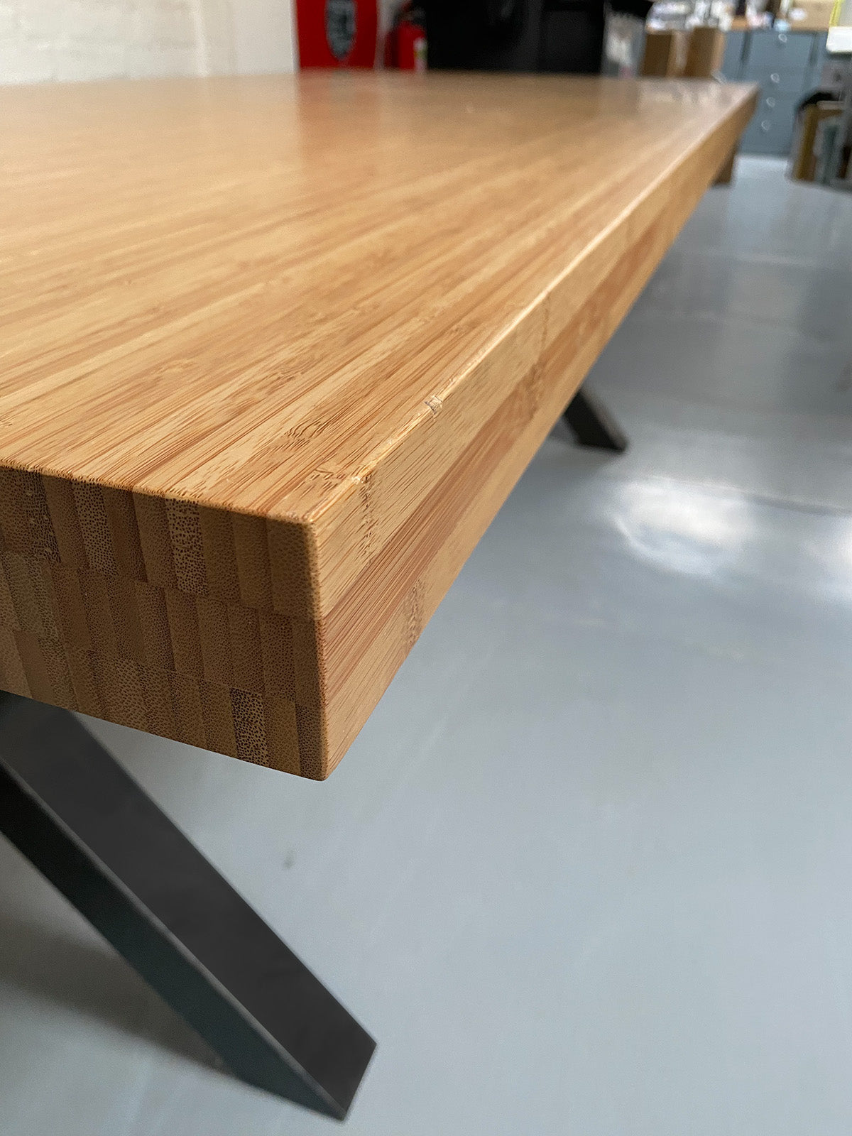 Bamboo table, detail of end side and metal base