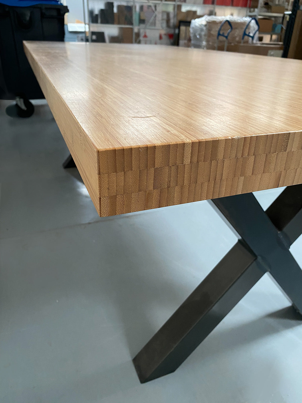 Bamboo table, close-up of top and black metal leg