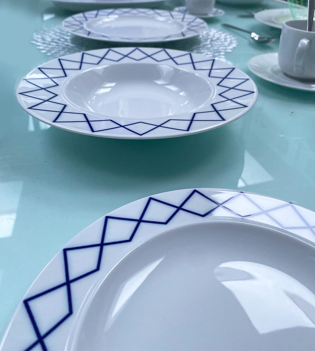 Detail of blue geometric decoration on rim of deep plate