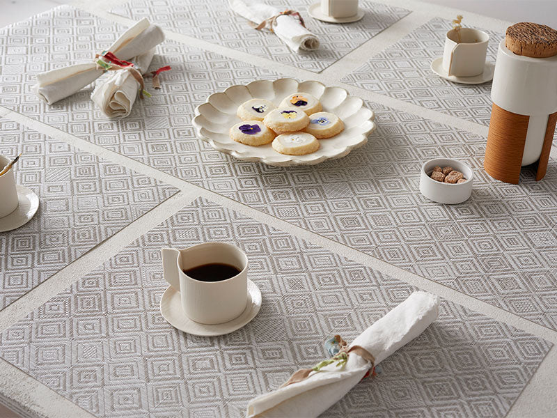 Beautiful Chilewich placemats, designed by Sandy Chilewich, set with cups and napkins