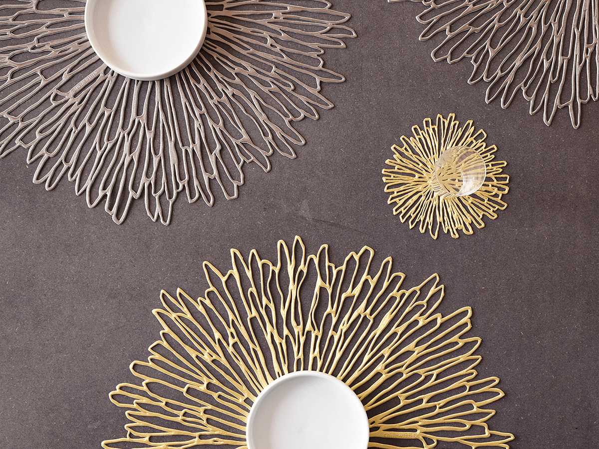 Chilewich beautiful Bloom placemats as base under a bowl, in gunmetal and gold