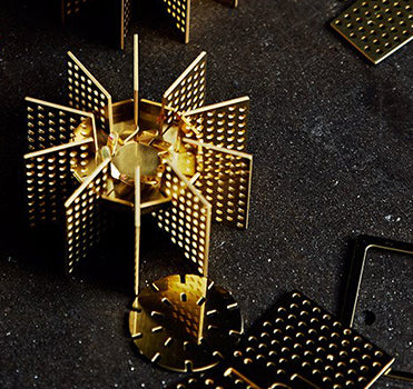 Fundamental Klick candle holder in perforated brass, assembled