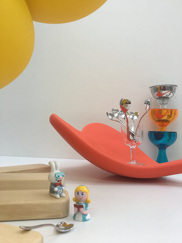 Large ice cream spoon with small figurines showing scale