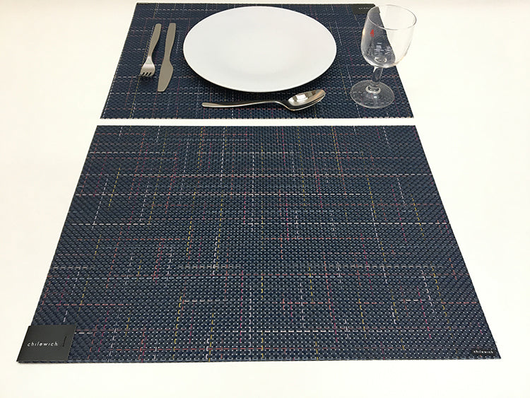 Chilewich Fireworks placemat, dark blue woven, set with plate and cutlery