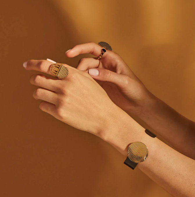 Alessi Edone ring in gold and black, worn with a strap