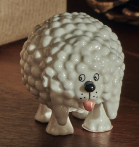 Cagnottone dog, dog figurine with white curls, side view