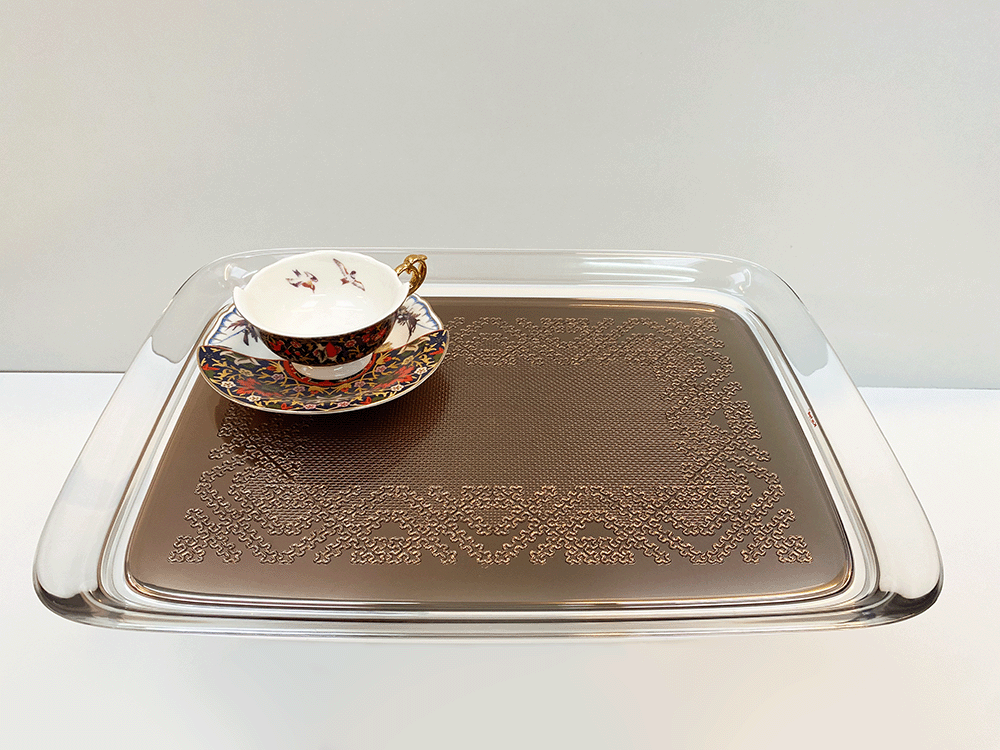 Teatime tray in bronze with cup and saucer, designed by Starck for Kartell