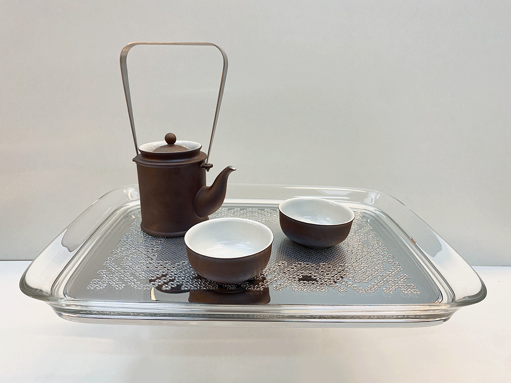 Kartell Teatime tray in chrome, with brown teapot and two small bowls