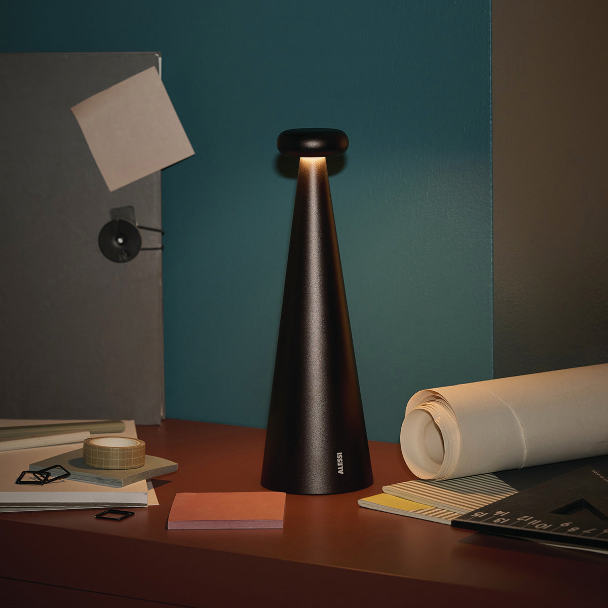 Bedin lamp in brown, lit on worktop