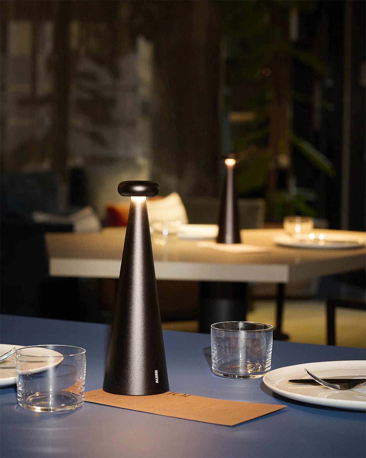 Two Bedin lamps in brown on a laid table