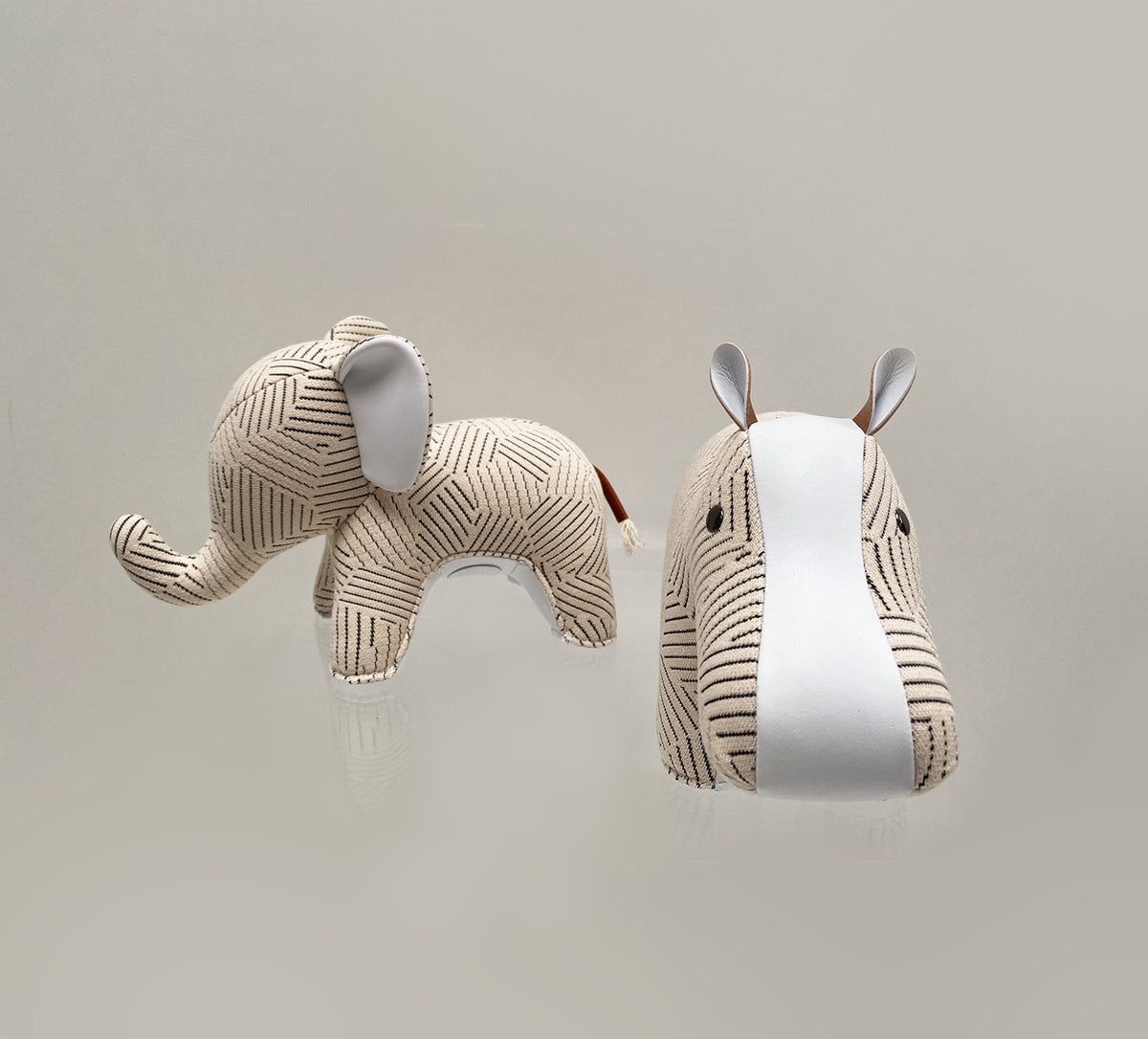 Zuny hippo bookend in white next to elephant statue