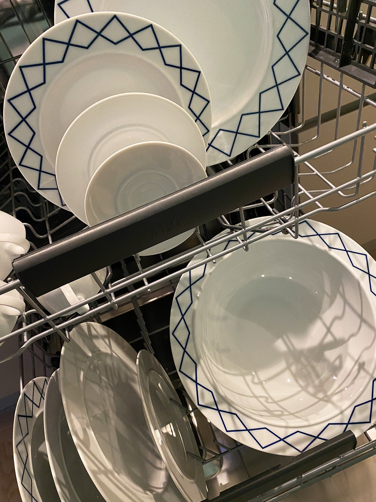 Detail of wide rim with blue decoration, bowl in dishwasher