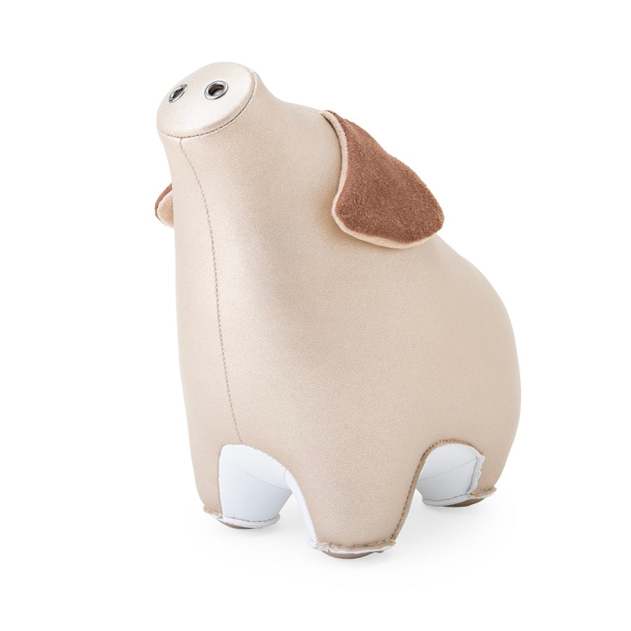 Zuny Pig Diya paperweight, pearl gold faux leather, brown ears, viewed at an angle from front